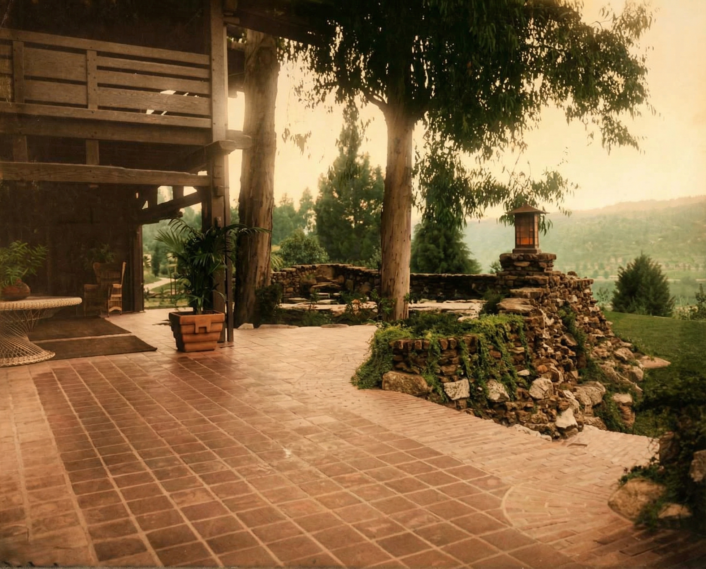 Historic colorized photograph of the Gamble House rear terrace circa 1908-1910 with views of the Arroyo Seco.