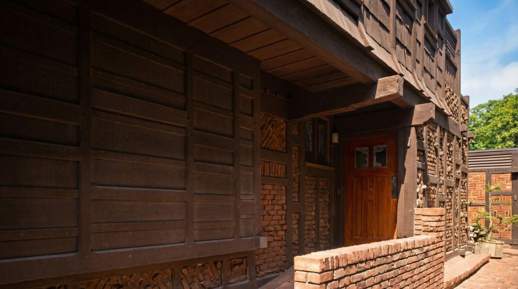 Historic colorized photograph of entrance door and walkway showing Arts and Crafts details at Adelaide Tichenor house