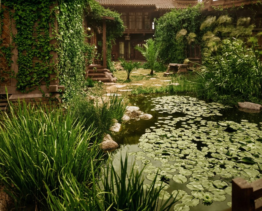 Historic colorized photograph of Japanese-inspired garden pond and landscaping at Adelaide Tichenor house, circa 1905