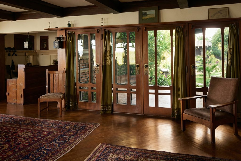 Historic colorized photograph showing interior view from living room toward courtyard at Adelaide Tichenor house