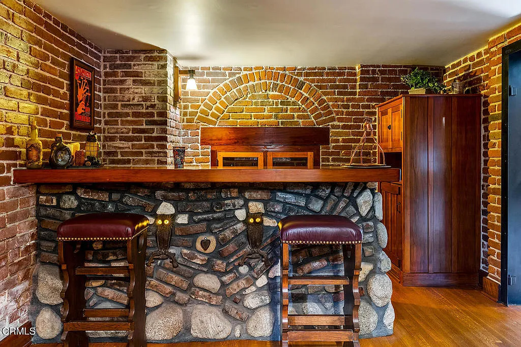 Basement bar area of the Laurabelle A. Robinson House with wood cabinetry, stone countertops, and Arts and Crafts details