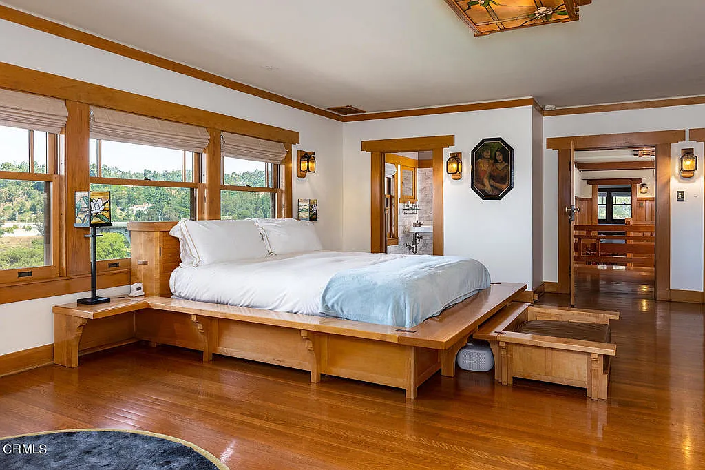 First bedroom in the Laurabelle A. Robinson House with hardwood floors, built-in cabinetry, and canyon view windows
