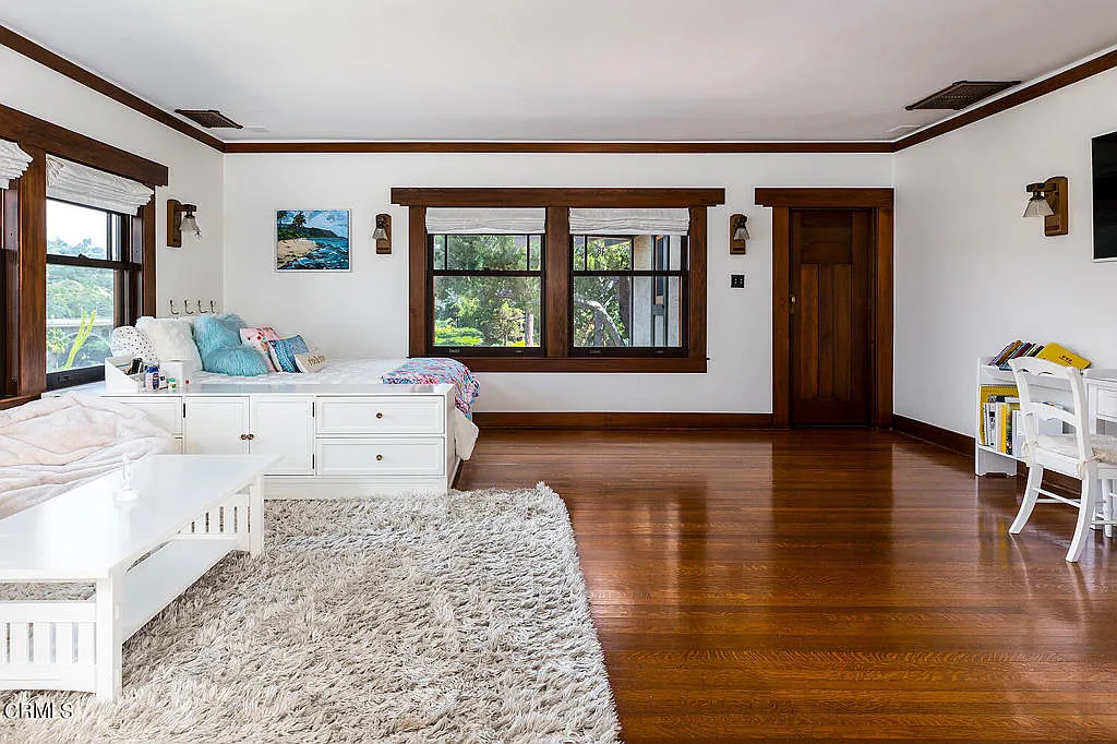 Fourth bedroom in the Laurabelle A. Robinson House with hardwood floors, white walls, built-in cabinetry, and canyon views