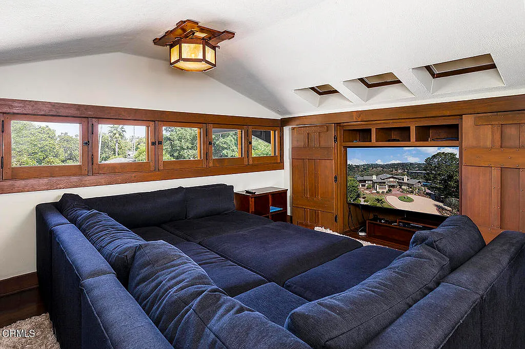 Entertainment room in the Laurabelle A. Robinson House with comfortable seating, exposed beams, and canyon view windows