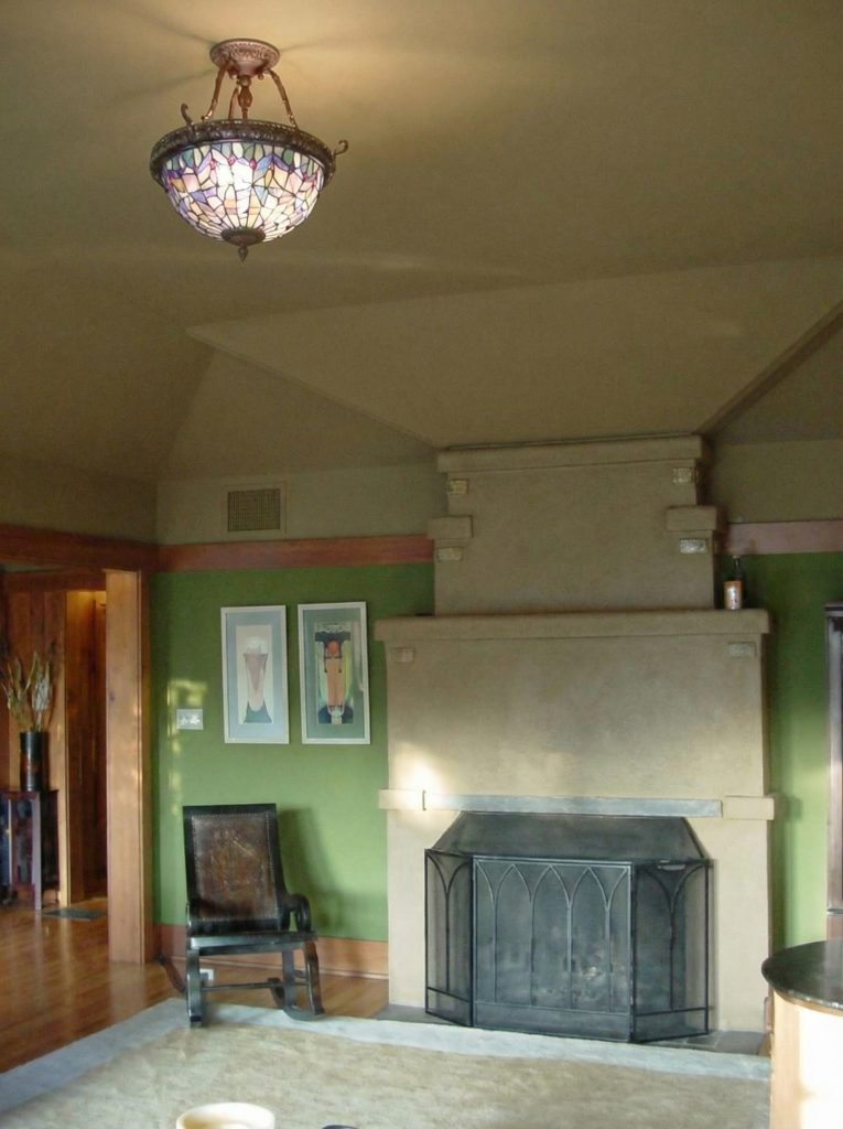 Living room interior showing octagonal bay window, exposed timber details, and Greene & Greene furniture pieces