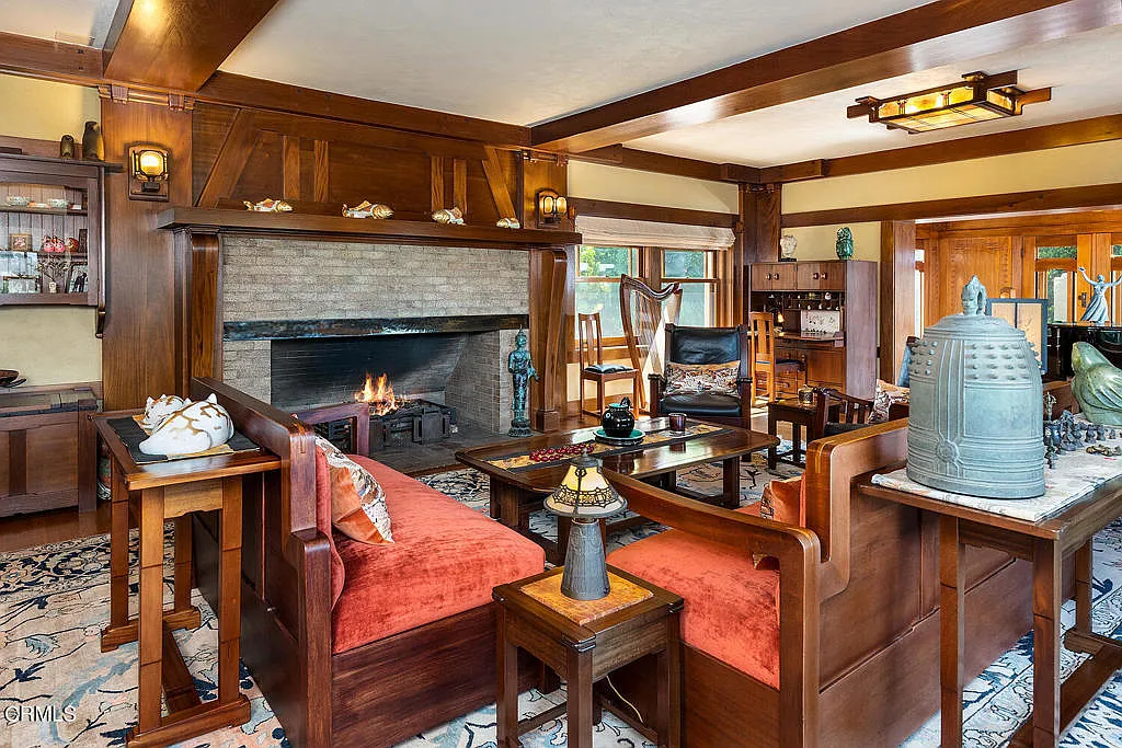 Living room fireplace of the Laurabelle A. Robinson House with stone surround, wood mantel, and Arts and Crafts detailing