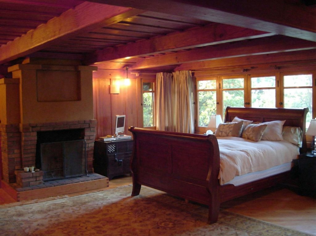 Master bedroom of Charles S. Greene House with natural light and Arts and Crafts design aesthetic throughout