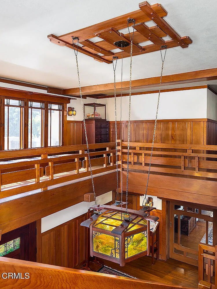 Second floor stairwell of the Laurabelle A. Robinson House with wood paneling, built-in seating, and Arts and Crafts details
