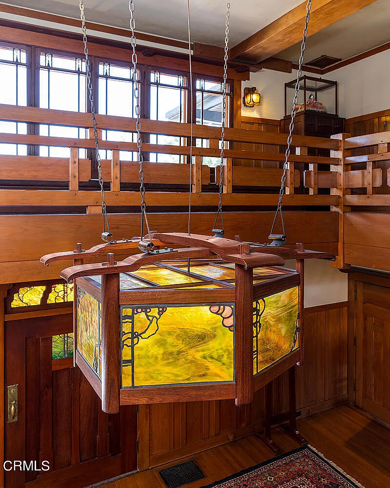 Second floor stairwell of the Laurabelle A. Robinson House featuring Arts and Crafts chandelier and wood balustrade