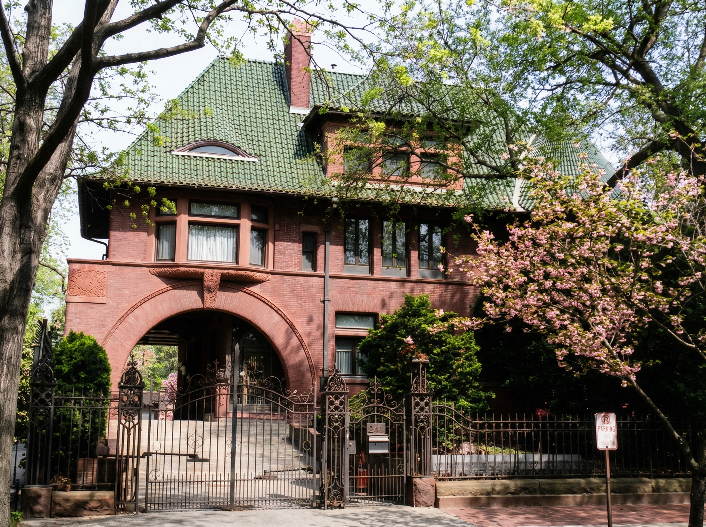 The Pratt family residence at 241 Clinton Avenue, Brooklyn, featuring Romanesque Revival arches and ivy-covered brick facade.