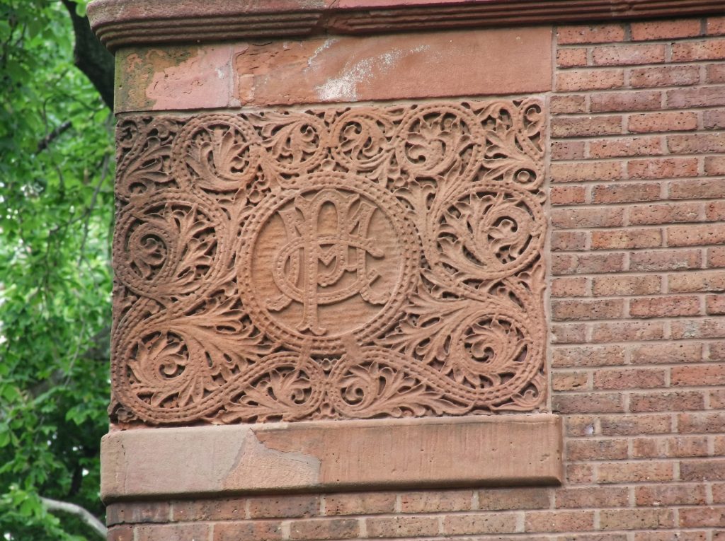 Ornate terracotta relief panel with Chinese characters on the Pratt family Brooklyn residence at 241 Clinton Avenue.