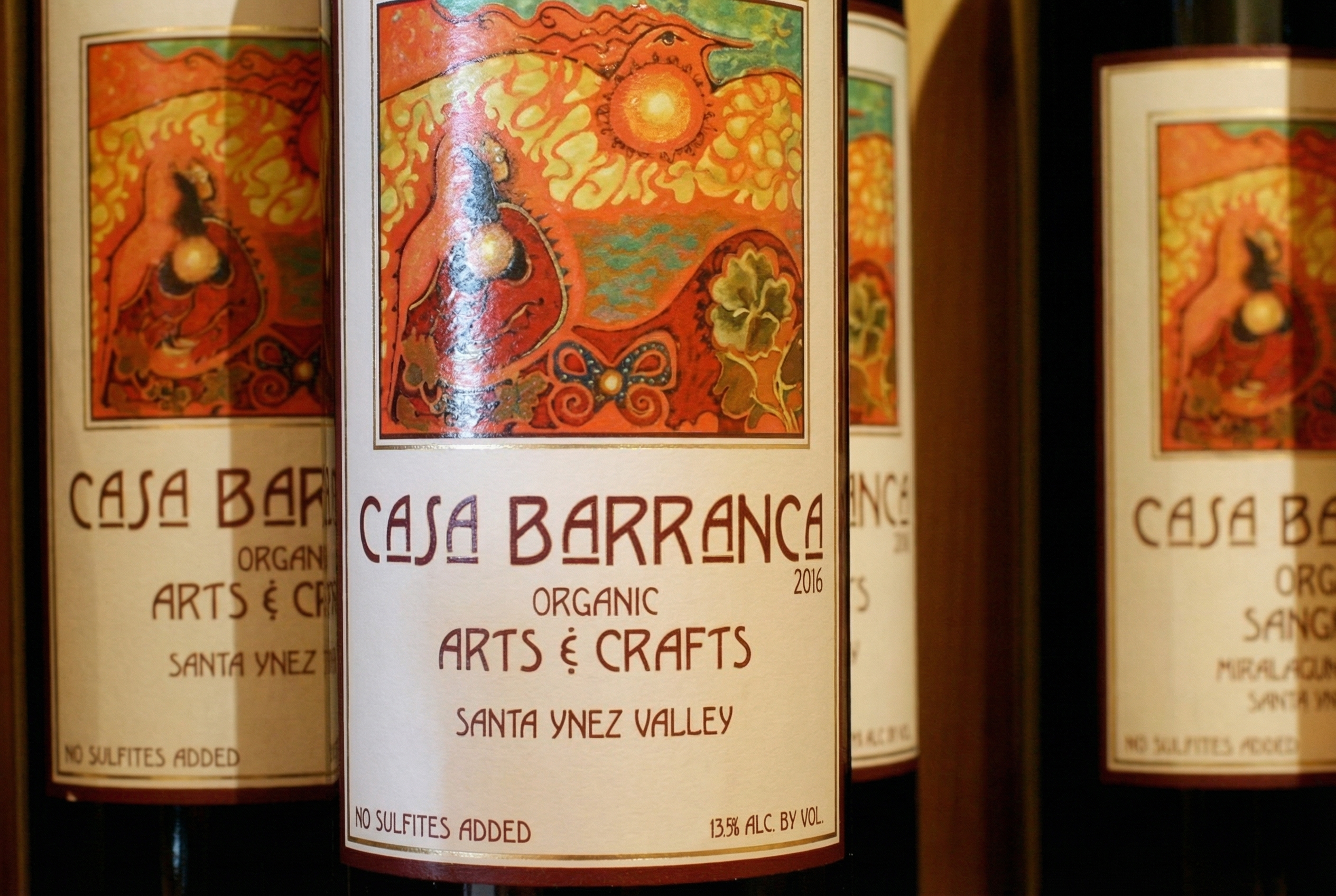 Casa Barranca organic wine bottles featuring Arts and Crafts-inspired labels, produced at the historic Pratt House estate winery.