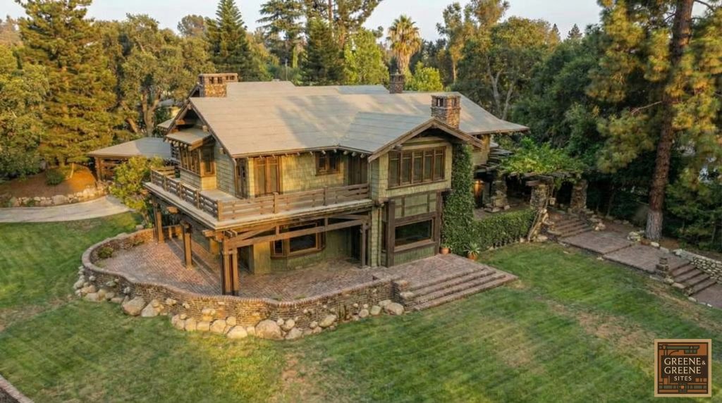 Aerial front view of The Duncan-Irwin House at golden hour, revealing its expansive grounds and design.