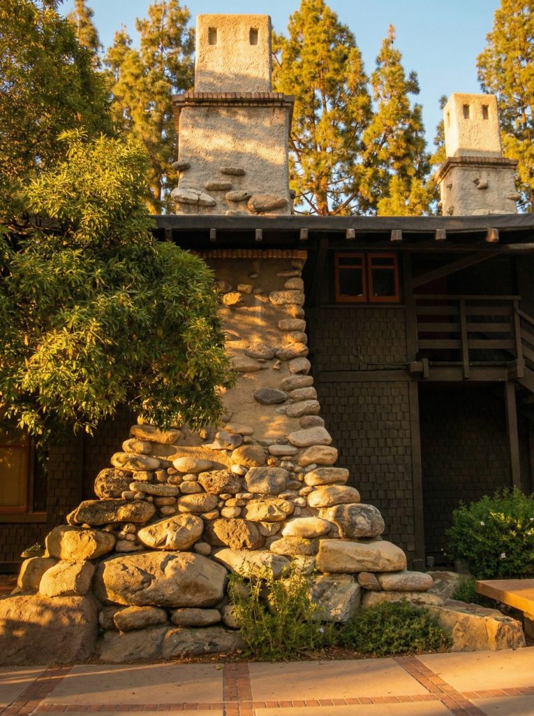 Alternate angle of the boulder chimney at The Mary E. Cole House rising through the roofline