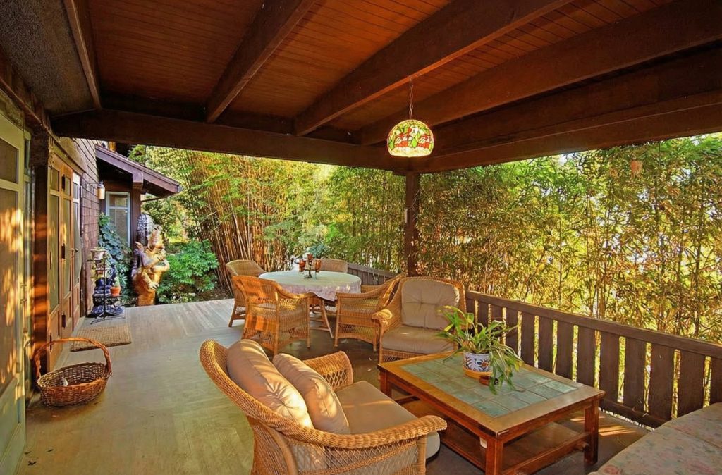 The spacious wooden deck of The Caroline S. de Forest House, overlooking the Arroyo Seco and surrounded by mature trees.