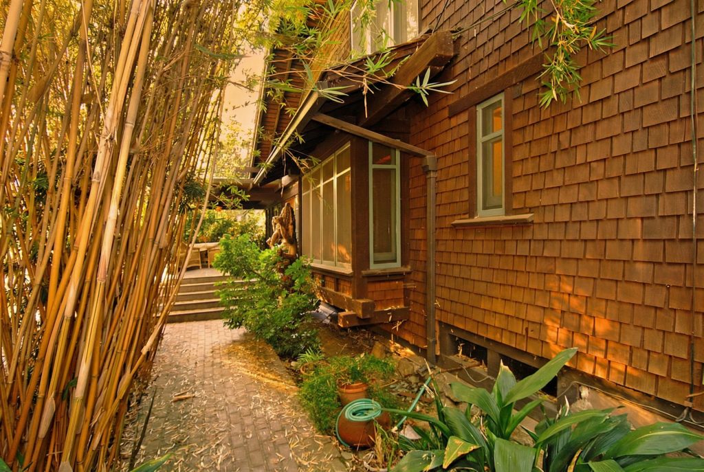 The meandering walkway leading to the entrance of The Caroline S. de Forest House, with its characteristic Craftsman details.