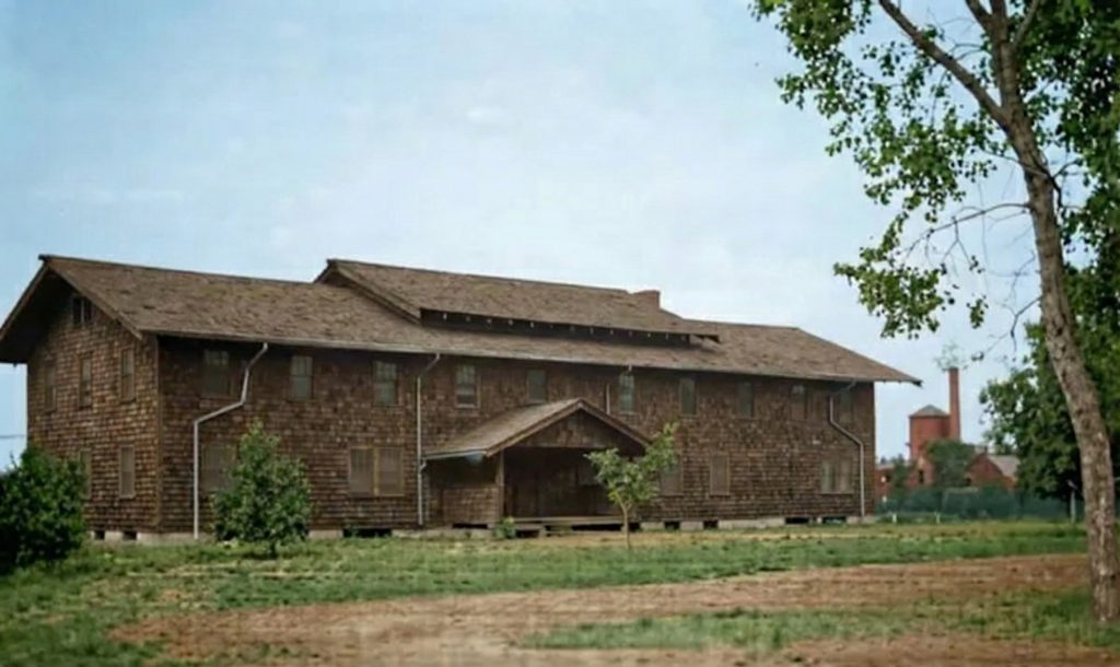 Front exterior photograph of The Charles W. Leffingwell Bunkhouse showing portico and timber details