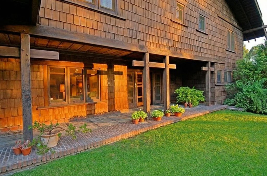 Covered front terrace with timber beams and cedar details at The Margaret B. S. Clapham Spinks House.