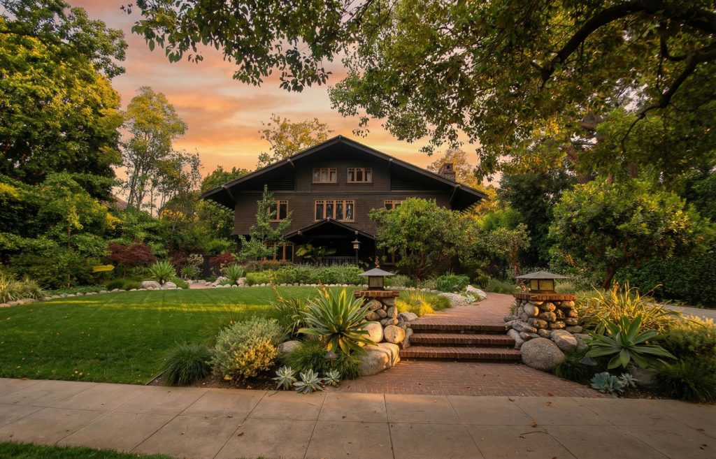 Expanded sidewalk view of the John Bakewell Phillips House capturing its three-story Swiss Chalet-style elevation.