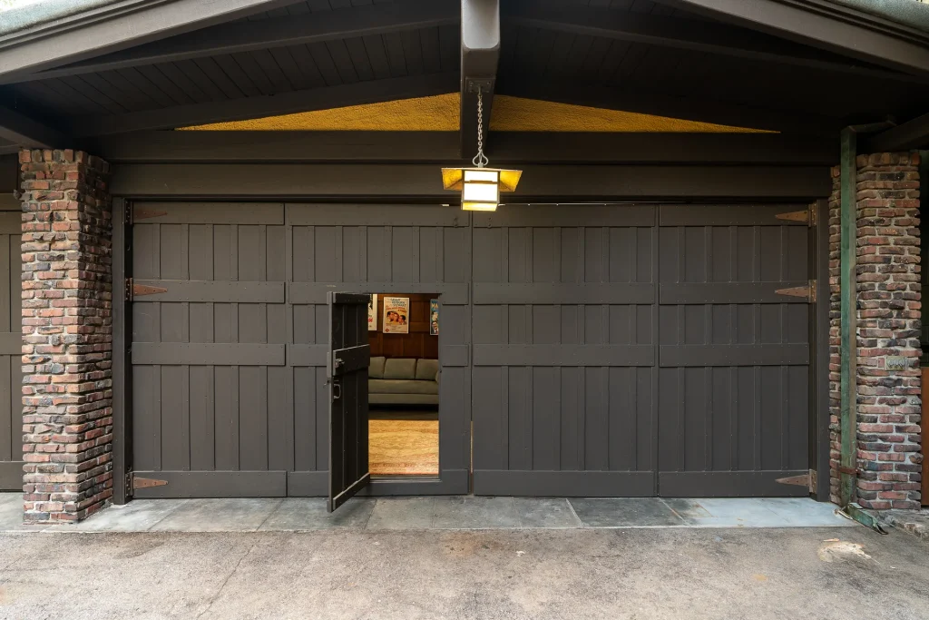 The Duncan-Irwin House three-car garage with Arts and Crafts detailing and timber-supported overhang.