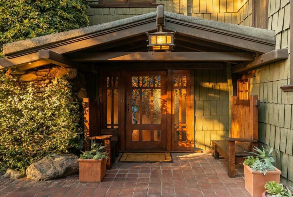 Grand entrance of The Duncan-Irwin House featuring art glass door and craftsman architectural details.