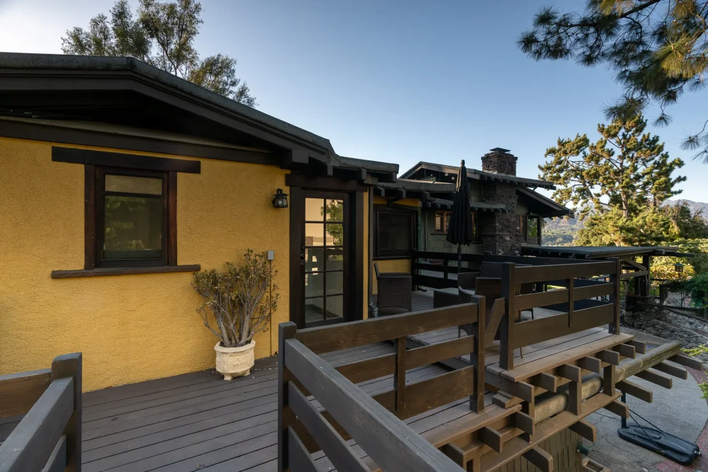 Private deck of The Duncan-Irwin House guest house, featuring craftsman railings and mountain views.