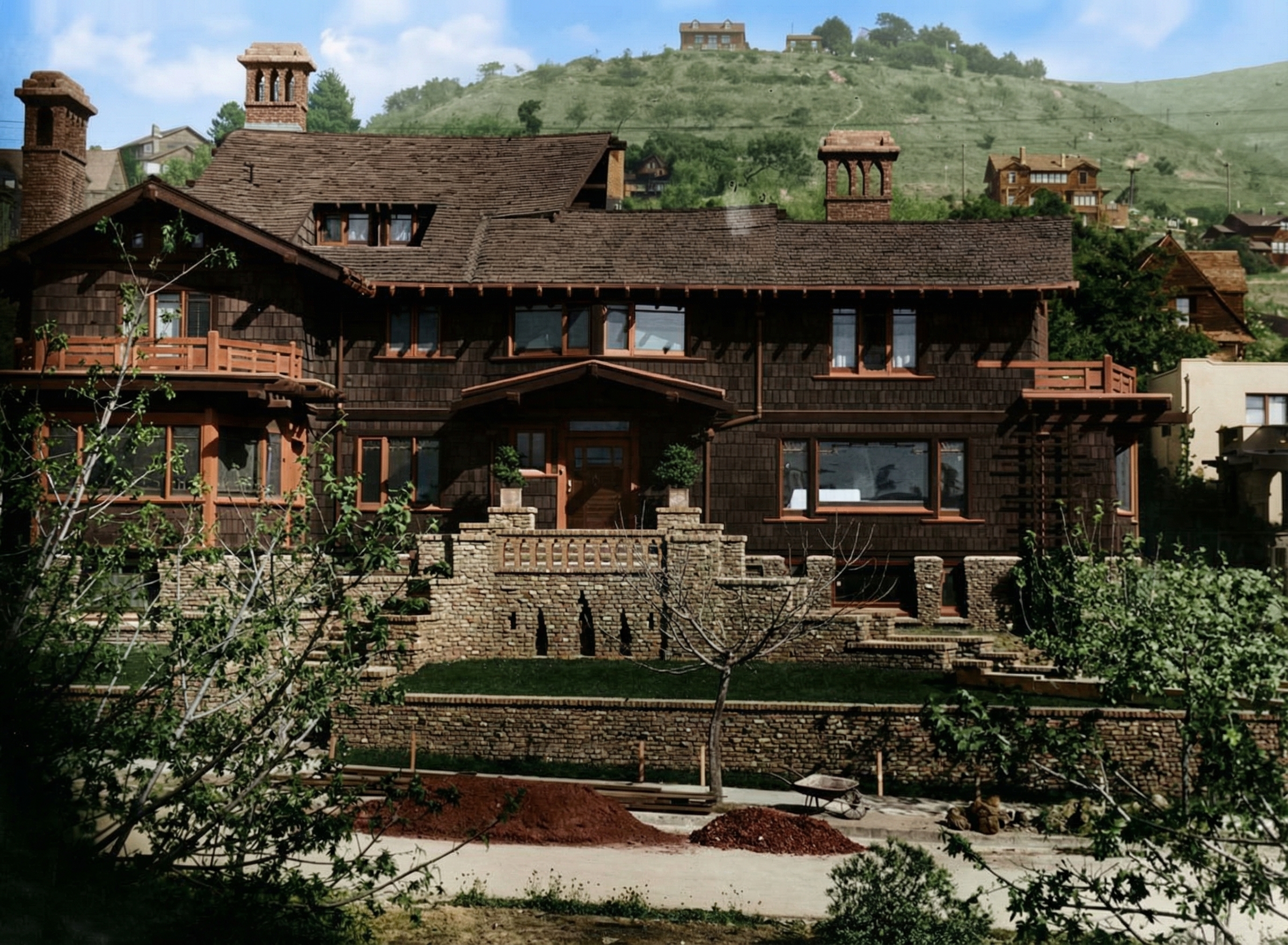 Early 1900s distant view of Thorsen House showing terraced gardens, timber bridge, and Berkeley hillside setting