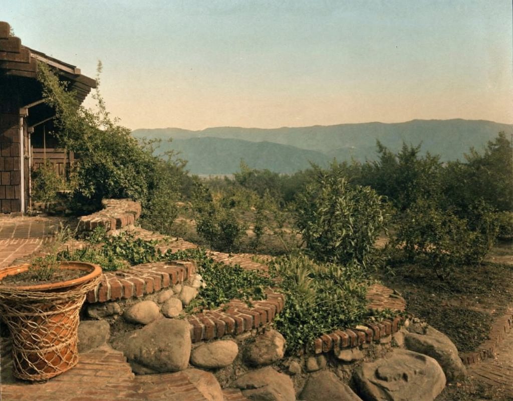 Historic three-tiered flower bed at The Charles M. Pratt House with stone walls, plantings, and garden pathways