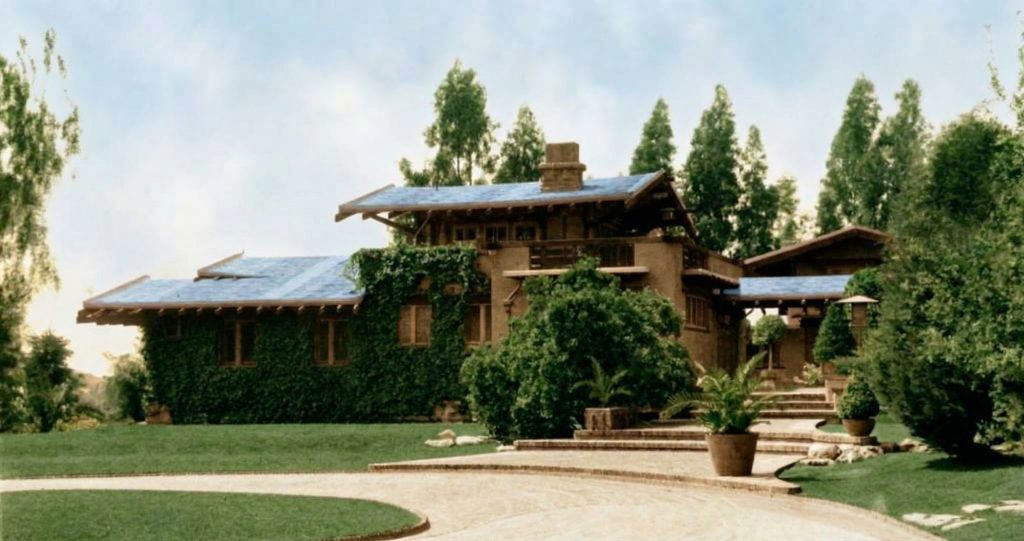 Historic colorized photograph of the east facade of the Freeman A. Ford House from the right side of driveway.
