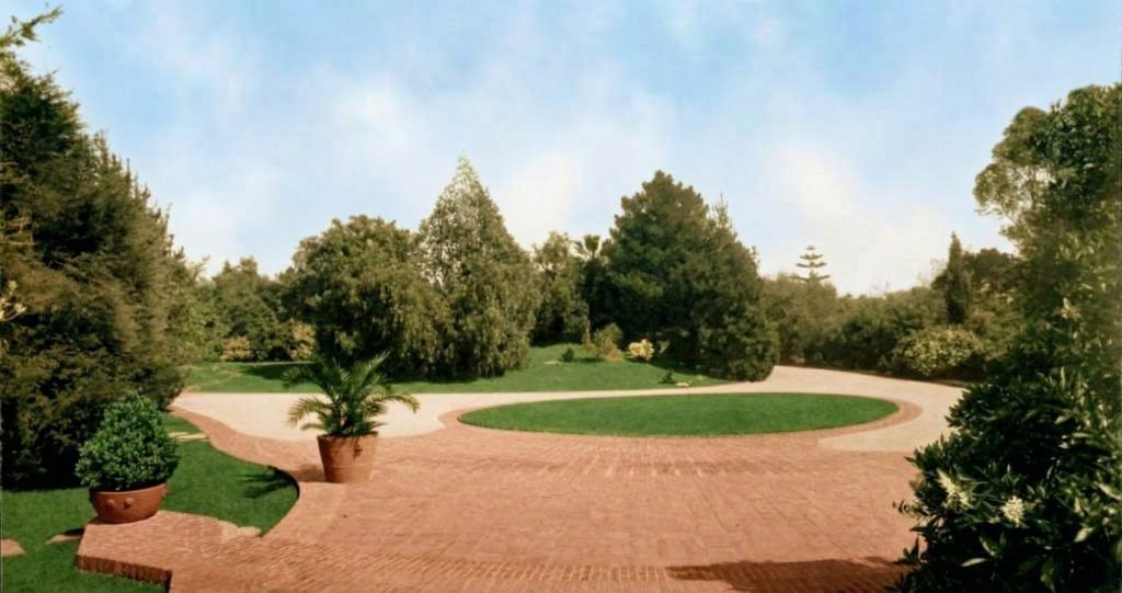 Historic colorized photograph of the driveway and motor court of the Freeman A. Ford House.