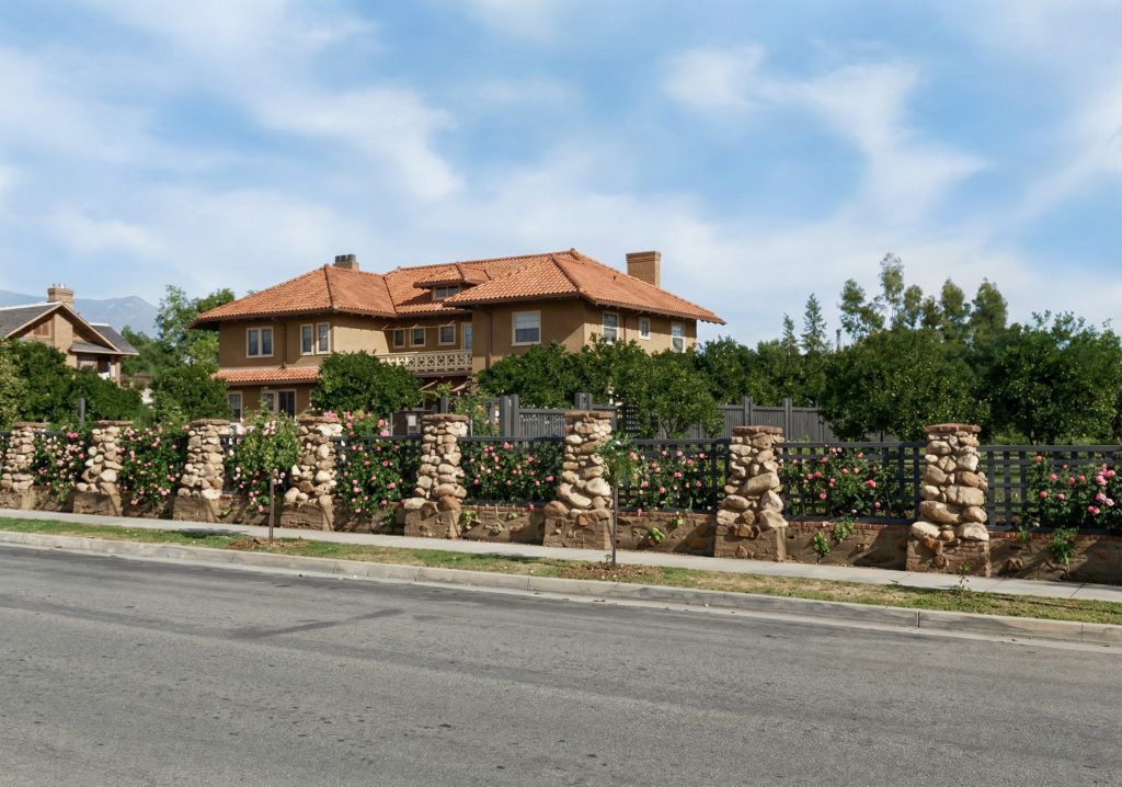 Historical photograph of The Judge Joseph H. Pryor House rear facade with original river rock pillars.