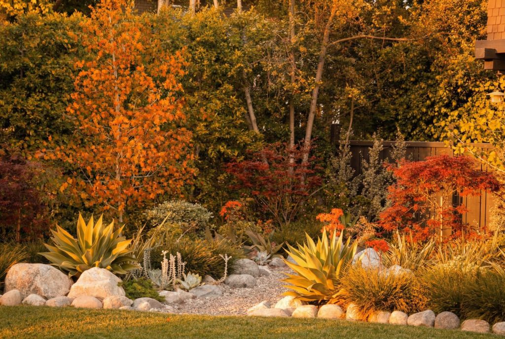 Landscaped grounds of the John Bakewell Phillips House featuring the serpentine brick path and naturalistic plantings.