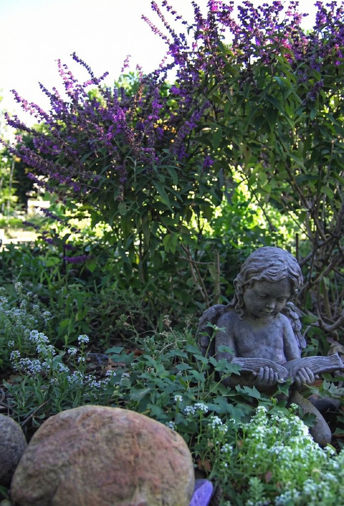 Landscaping view of The Charles M. Pratt House with terraced gardens, stone retaining walls, and mature landscaping