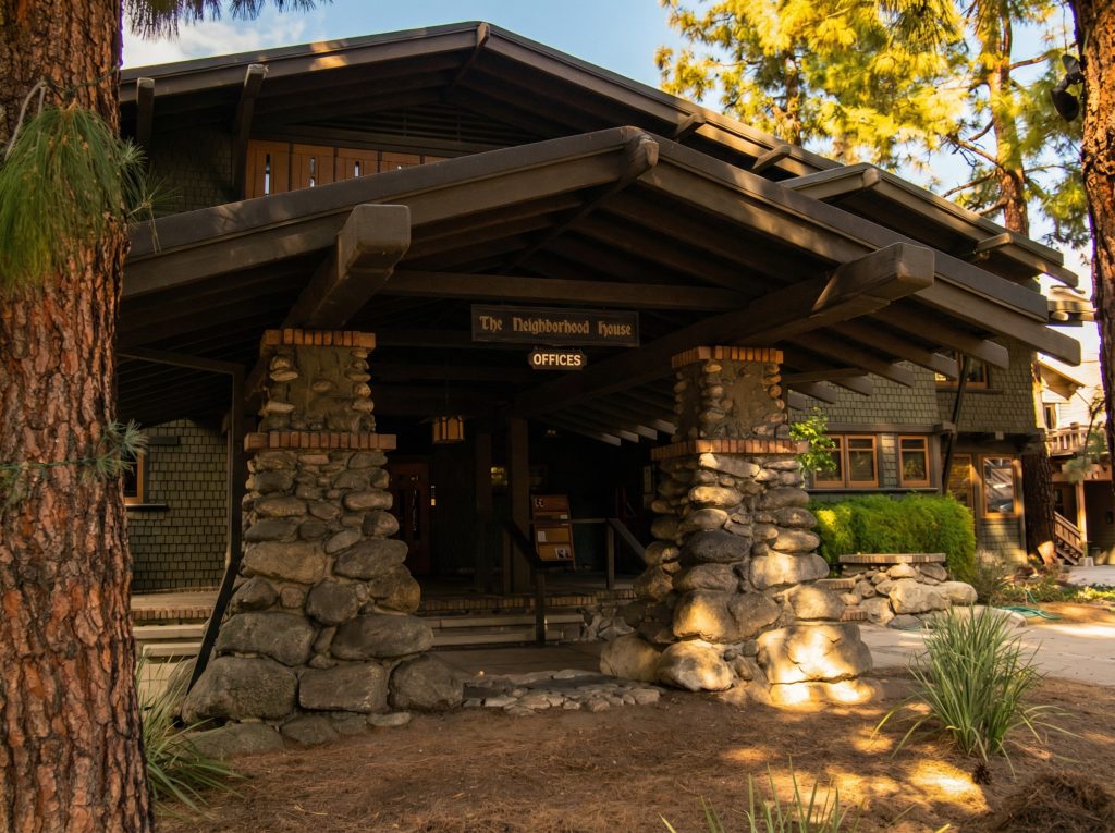 The porte-cochere at The Mary E. Cole House with massive arroyo boulder supports and timber beams