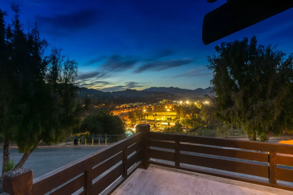 Twilight view of The Duncan-Irwin House second-floor deck with ambient lighting and architectural details.