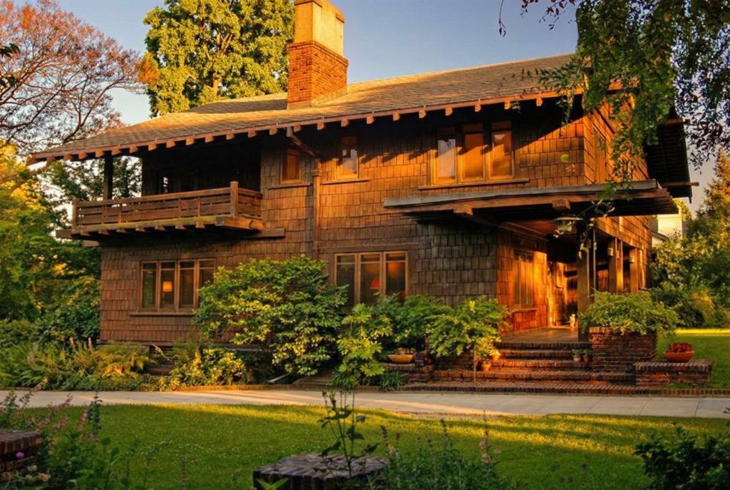 Side yard view showing layered gables and timber details at The Margaret B. S. Clapham Spinks House.