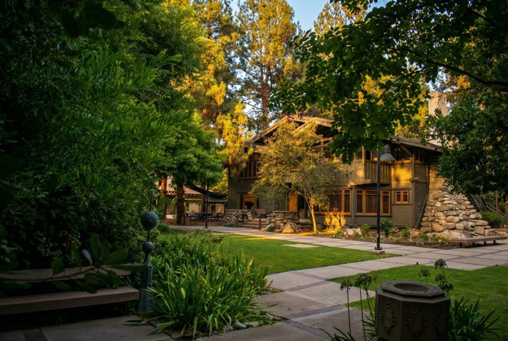 Expanded southwest corner view of The Mary E. Cole House with gardens and horizontal rooflines