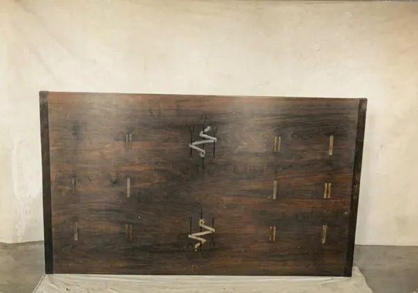 Underside of the Mrs. Belle Barlow Bush furniture dining table showing extension mechanism and mahogany construction
