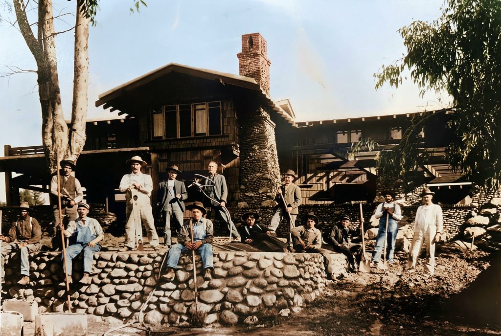 Colorized historic photo of The Duncan-Irwin House under construction with craftsmen and materials.