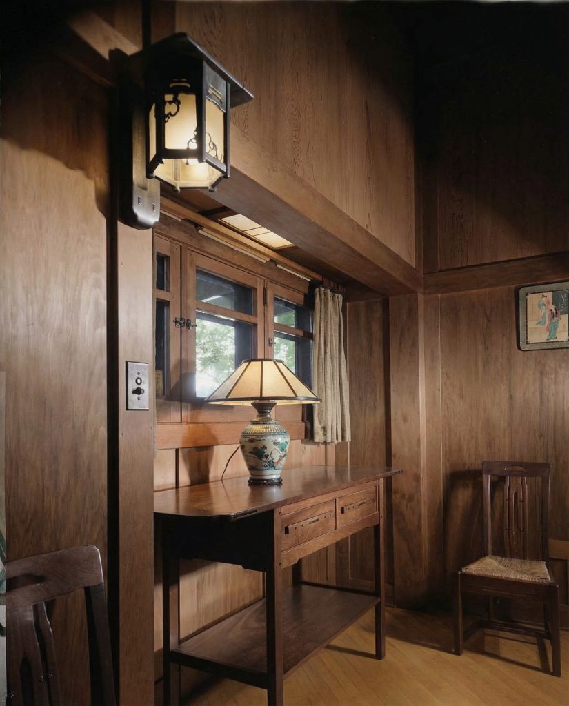 Colorized dining room wall of The Charles M. Pratt House with wood paneling, built-in cabinetry, and Arts and Crafts details