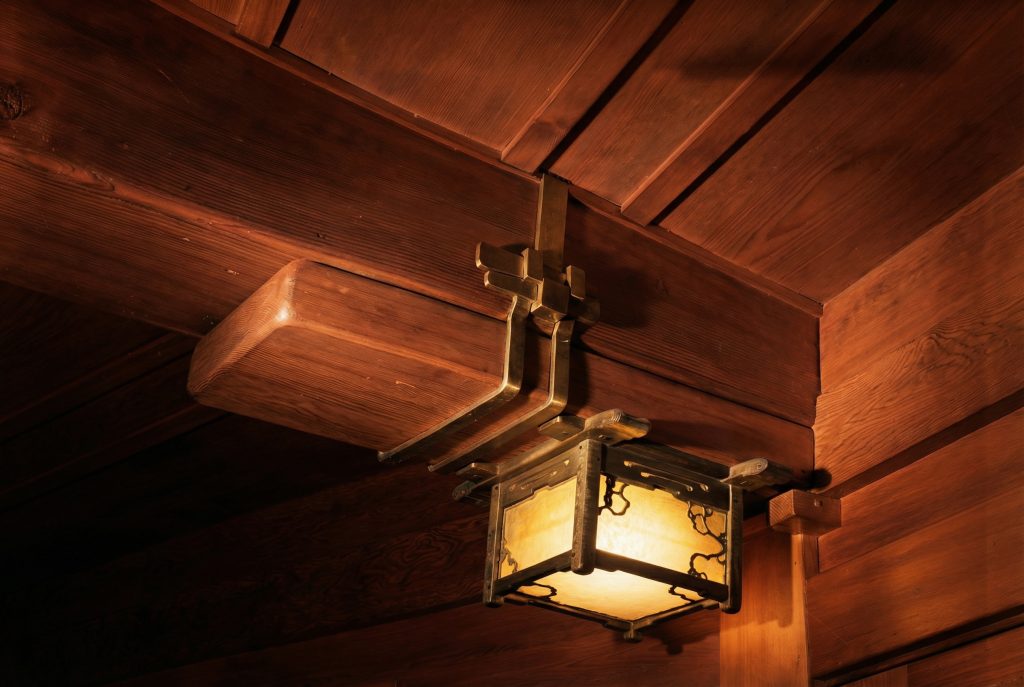 Colorized interior light fixture detail of The Charles M. Pratt House with Arts and Crafts design and decorative elements