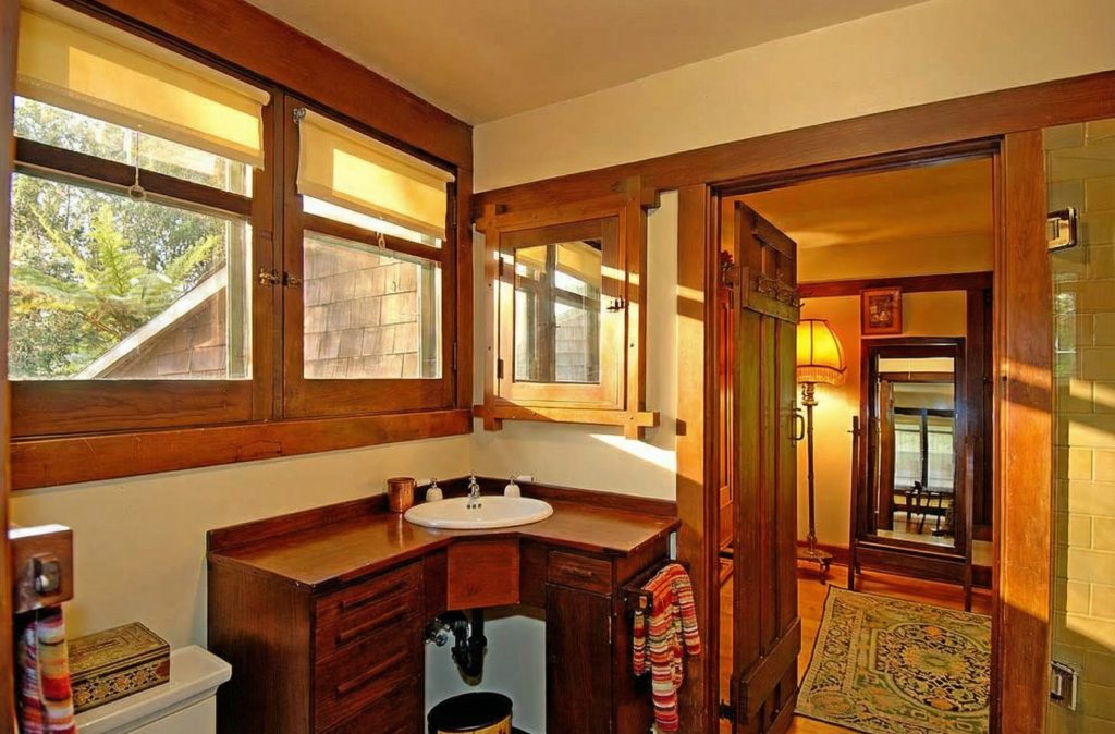 A bathroom in The Caroline S. de Forest House, featuring simple, elegant fixtures and fine woodwork, reflecting the home's unified aesthetic.