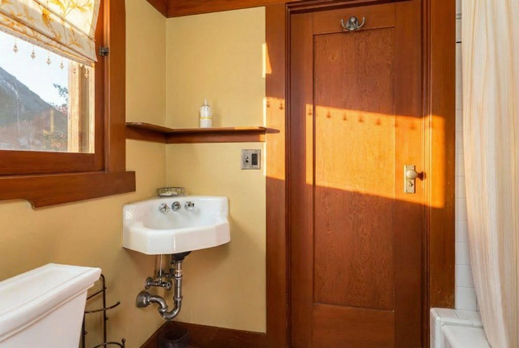 Restored bathroom with classic fixtures and tilework at The Margaret B. S. Clapham Spinks House.