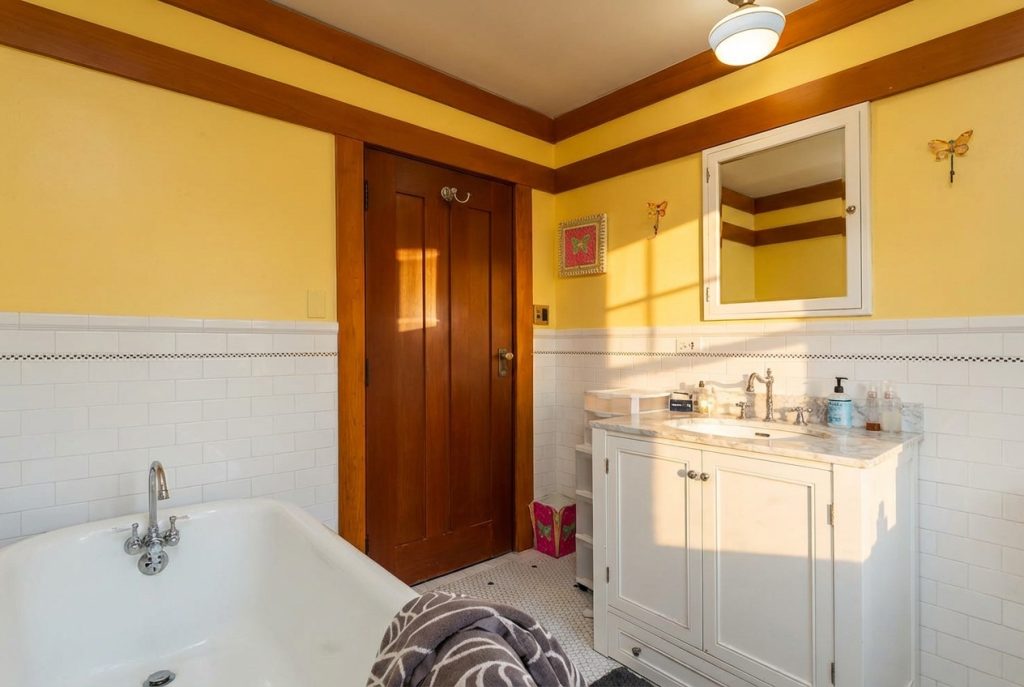 Bathroom with white subway tile and pedestal sink at The Margaret B. S. Clapham Spinks House by Greene & Greene.