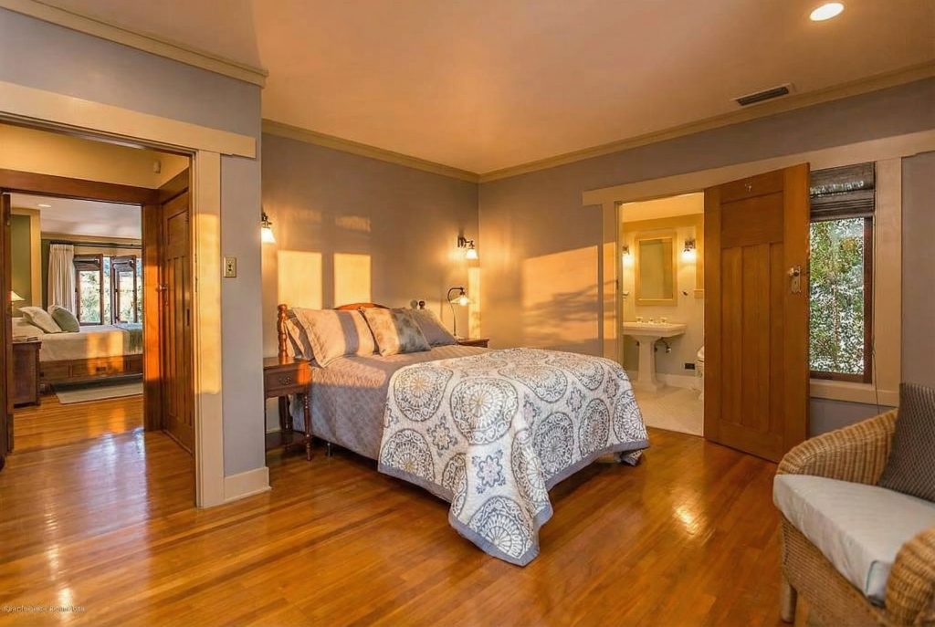 Bedroom 2 at The Dr. William T. Bolton House #3 with cozy window seat and wood paneling.