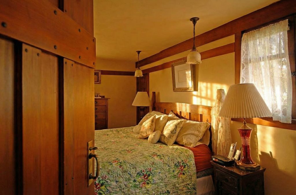 An alternate view of a bedroom in The Caroline S. de Forest House, highlighting the craftsmanship of the woodwork and built-in furniture.