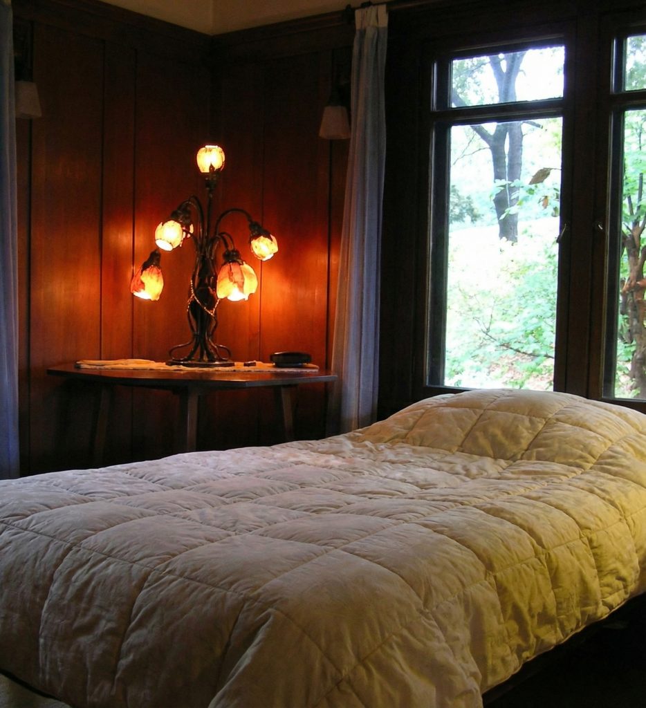 Third bedroom lamp at The Charles M. Pratt House with Arts and Crafts design, decorative shade, and period styling