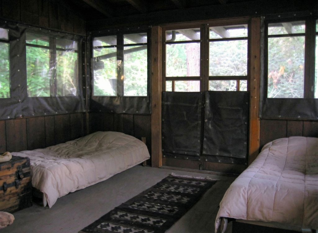 Sleeping porch at The Charles M. Pratt House with screened windows, wood floors, and open-air design for healthy sleeping