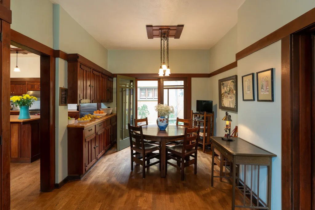 The Duncan-Irwin House breakfast nook with craftsman cabinetry and view to courtyard.