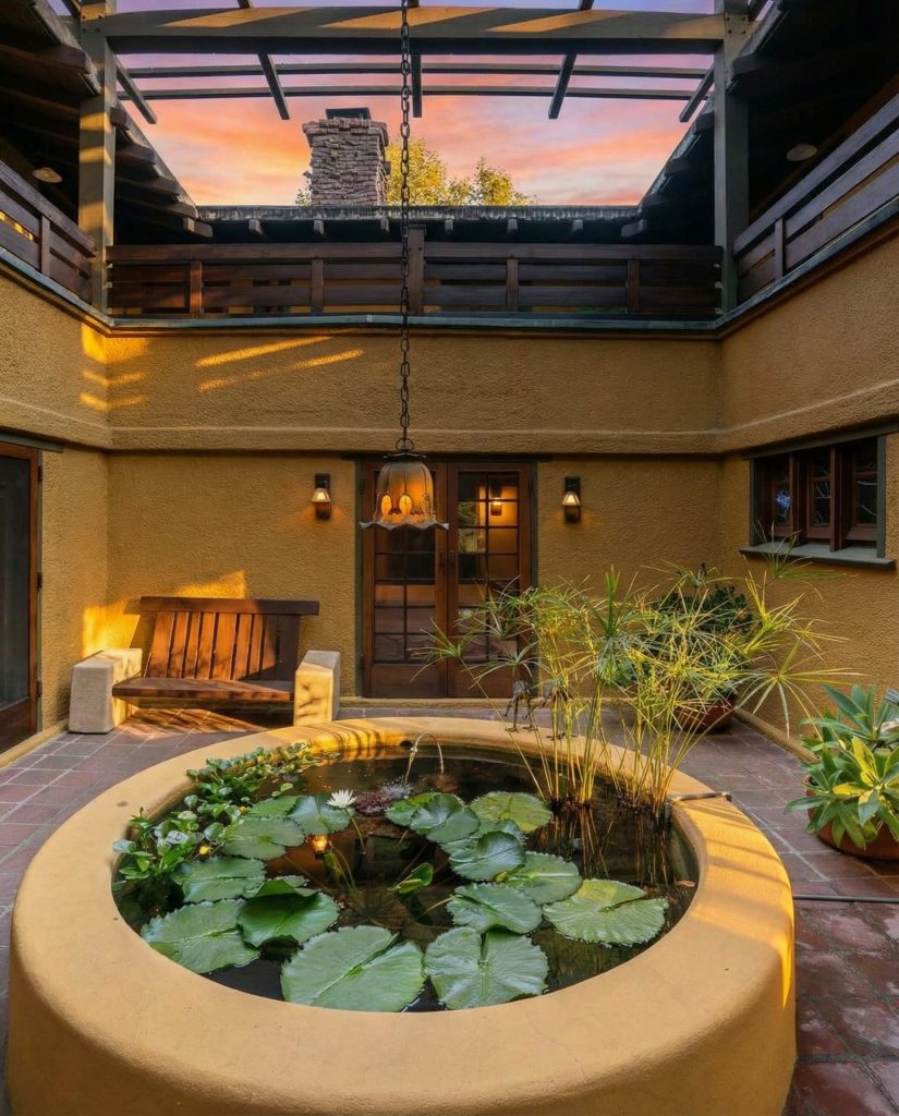 First-floor view of The Duncan-Irwin House central courtyard with fountain and ambient lighting.